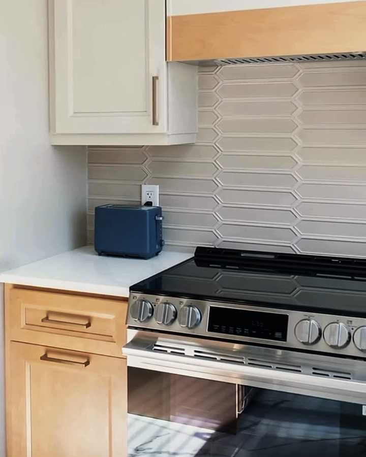 Finished kitchen with tile backsplash and new range